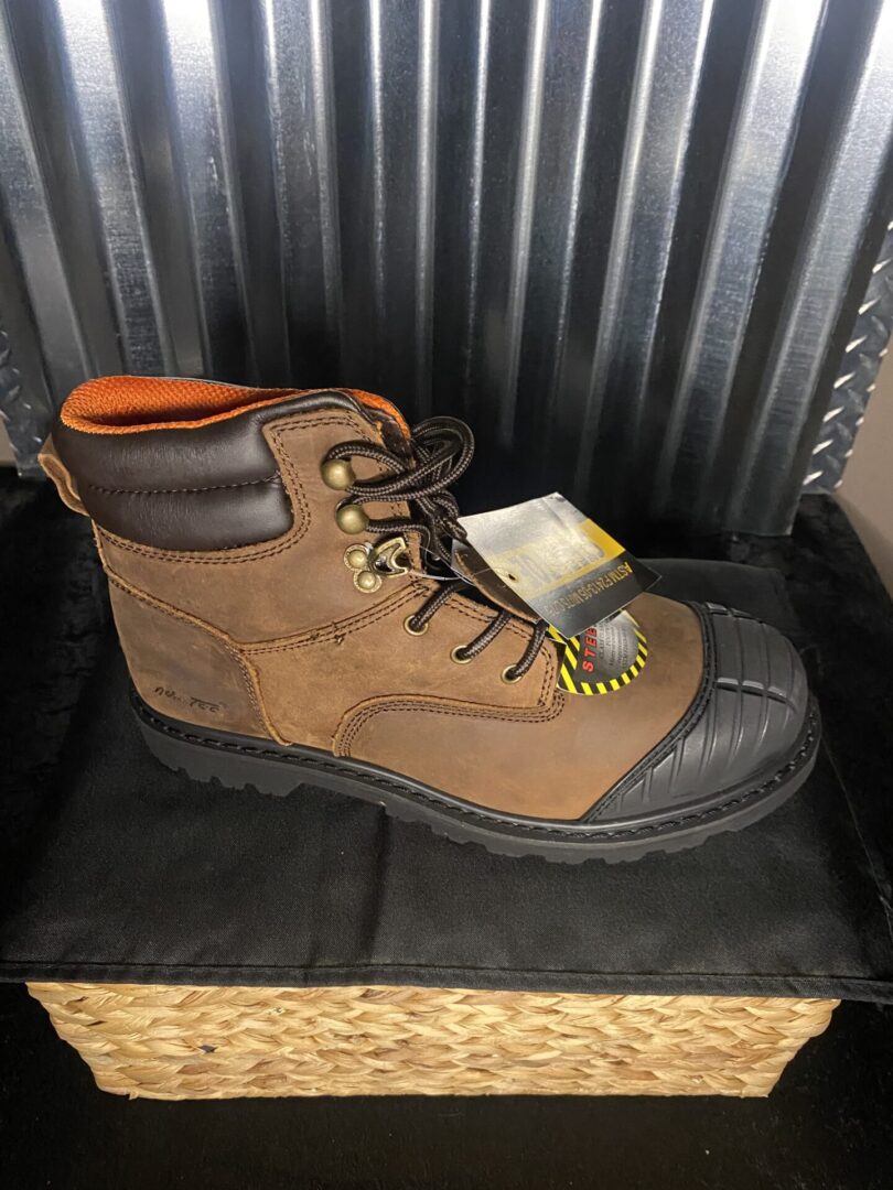 A pair of brown work boots sitting on top of a chair.