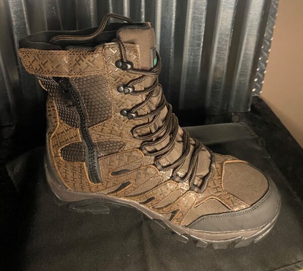 A pair of boots sitting on top of a metal surface.