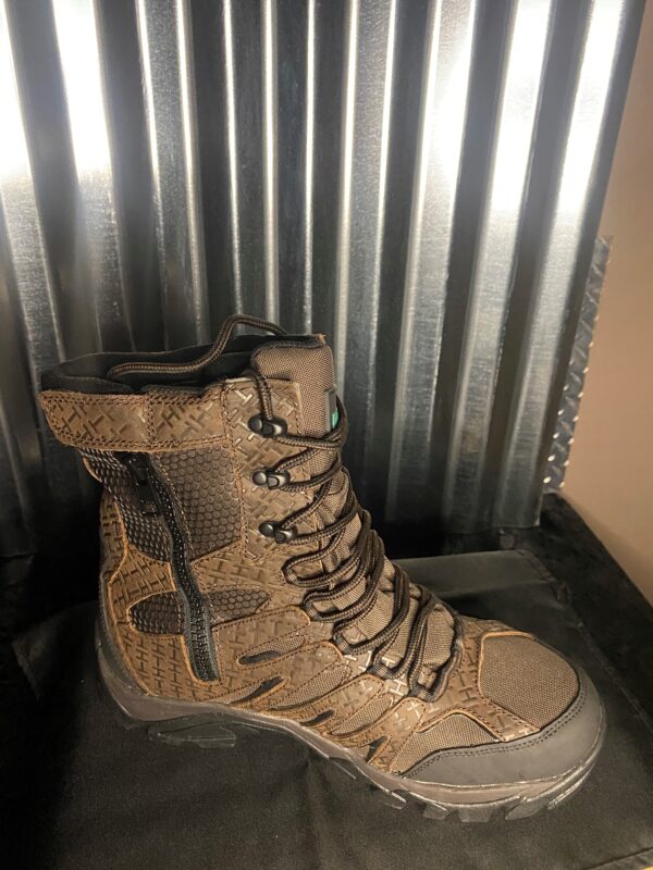 A pair of boots sitting on top of a metal wall.