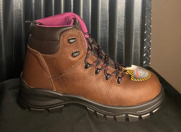 A pair of brown boots sitting on top of a table.